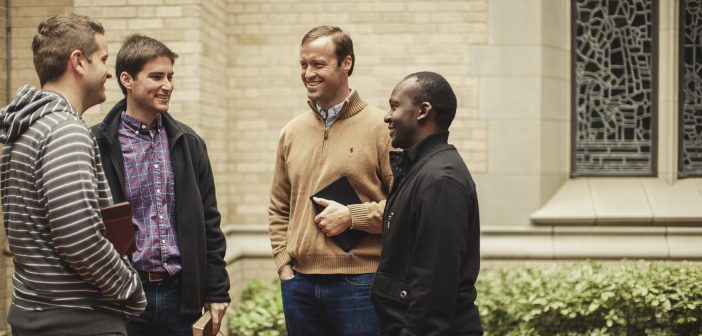 Photo of four people having a conversation