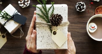 Photo of hands holding a wrapped Christmas gift