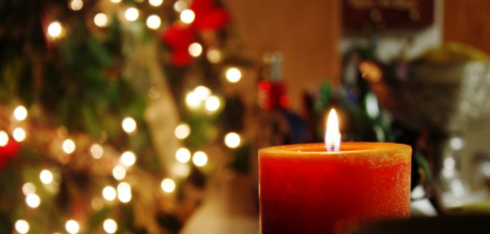Photo of a Christmas tree and burning candle