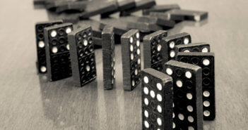 Dominoes precipitously lined up and ready to fall