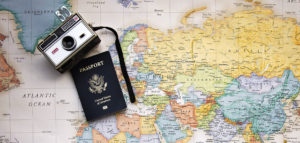 Passport and camera on a map of the world