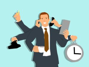 Cartoon illustration of a man with many arms juggling many tasks.