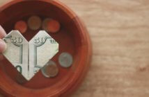 9 Ways Leaders Can Promote Faithful Stewardship Hand holding a $50 bill folded into a heart over an offering plate