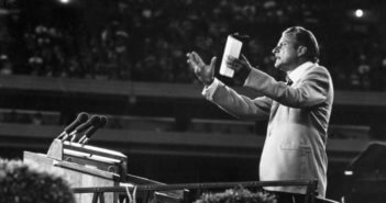 Billy Graham addresses a large crowd. CREDIT: Keystone / Getty Images / Universal Images Group, Rights Managed / For Education Use Only