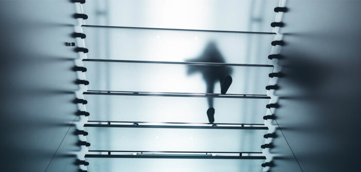 Person walking up a translucent staircase