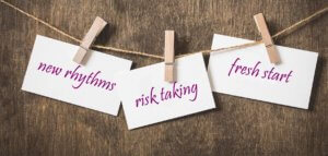 Note cards with handwritten words 'new rhythms' 'risk taking' and 'fresh start'