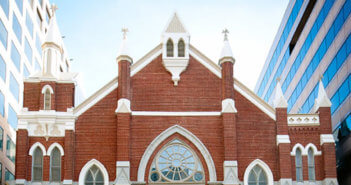 Streetscape showing Metropolitan African Methodist Episcopal Church among office buildings in downtown Washington, DC.