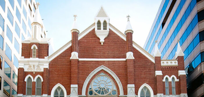 Streetscape showing Metropolitan African Methodist Episcopal Church among office buildings in downtown Washington, DC.