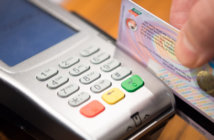 Lead, Learn, Launch: Getting Started with Digital Giving Close up of a person swiping a credit card through a credit card reader
