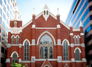 Streetscape showing Metropolitan African Methodist Episcopal Church among office buildings in downtown Washington, DC.