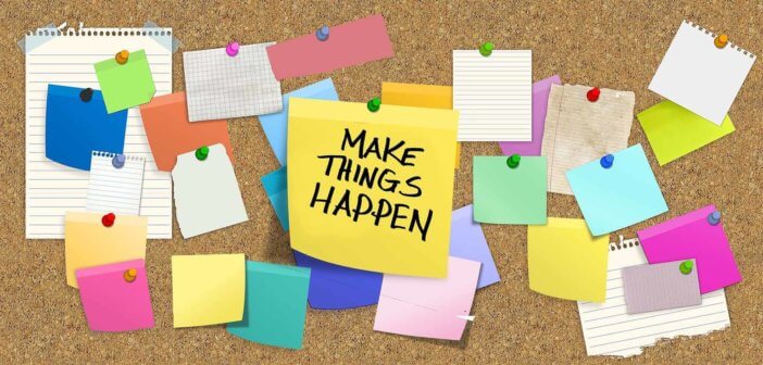 Cork board full of thumbtacked notes including a big one that says MAKE THINGS HAPPEN!