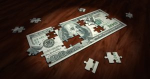 Photo of a jigsaw puzzle with a dollar bill