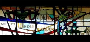 Stained glass window with the text Put on the Whole Armour of God