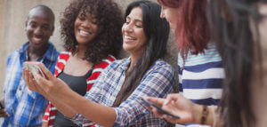 Diverse group of millennials taking a selfie