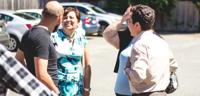 Folks having a friendly conversation in the church parking lot