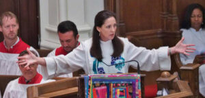 Rev. Ginger Gaines-Cirelli preaching from the pulpit