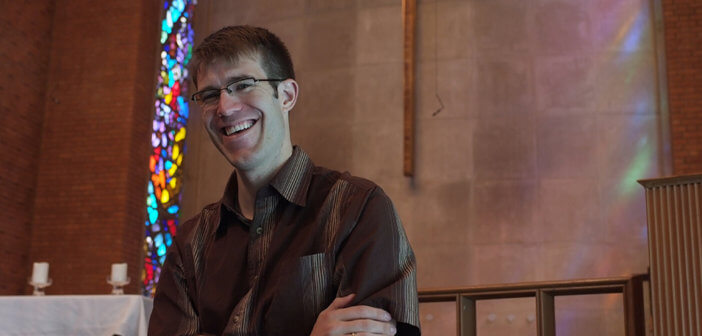 Smiling pastor standing at the chancel