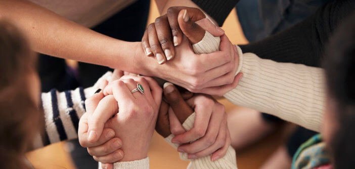 Close up of a group of people's hands clasped together