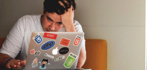 Visibly dismayed person looking at a computer screen