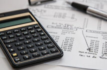 9 Questions to Assess Your Church’s Financial Health Calculator, ink pen and financial sheets