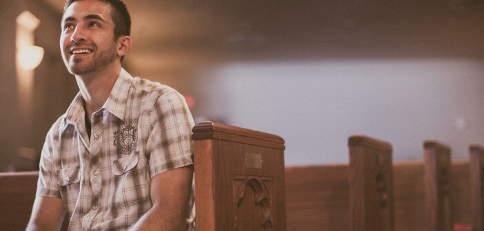 Smiling, attentive person sitting in a pew