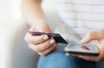 4 Ways to Involve Younger People in Stewardship Young person holding a credit card and mobile phone