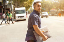 Young Clergy Effectiveness: Good News-Bad News Young pastor carrying a laptop bag while crossing a city street