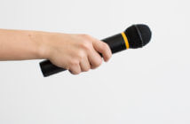 3 Welcoming Strategies that Can Backfire Hand passing a microphone to someone for an introduction