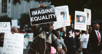 People at a protest march holding up signs