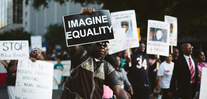 People at a protest march holding up signs