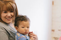Church Childcare Programs: Income Generators or Missional Opportunity? Smiling child care working holding a cute toddler