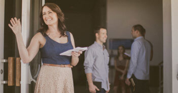 Friendly church greeter waving hello