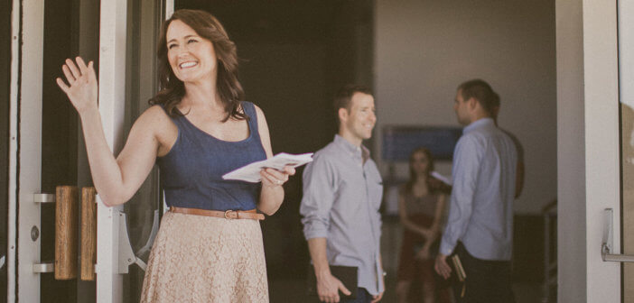 Friendly church greeter waving hello