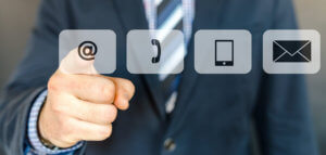 Finger pressing an @ icon