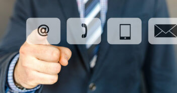 Finger pressing an @ icon