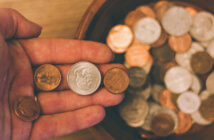 Never Fail to Attend Because You Can’t Contribute Close up of a hand dropping coins into a collection plate