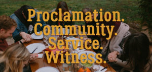 A small group praying together before dinner with superimposed words "Proclamation. Community. Service. Witness."
