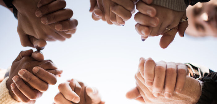 Hands of people of difference races clasped together