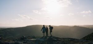 Hikers atop a large hill