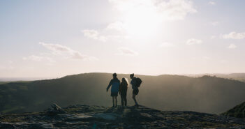 Hikers atop a large hill