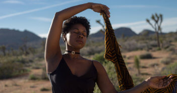 Person with closed eyes meditating in the desert