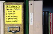 7 Policies Every Church Needs for Trust and Transparency Bookshelf with binder of church policies