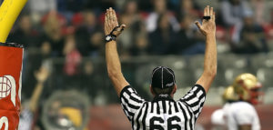 Football referee with arms raised for a touchdown