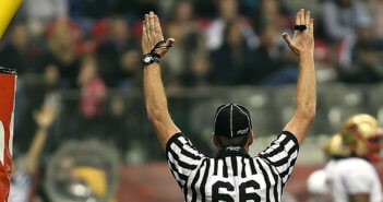 Football referee with arms raised for a touchdown