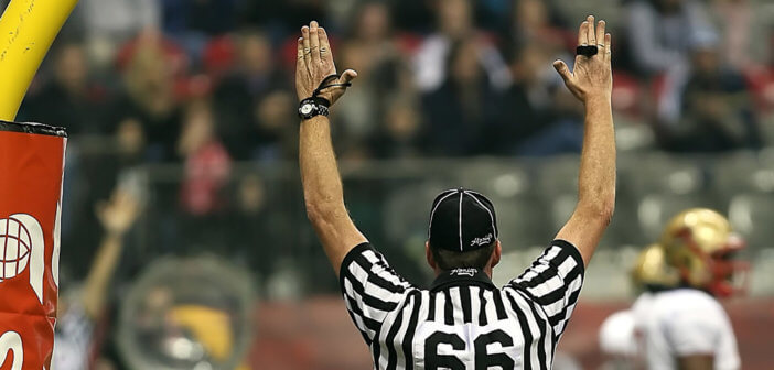 Football referee with arms raised for a touchdown