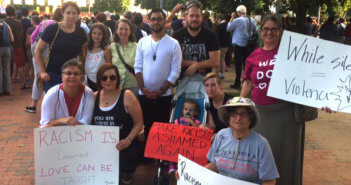 Washington Ethical Society members holding signs protesting white supremacy