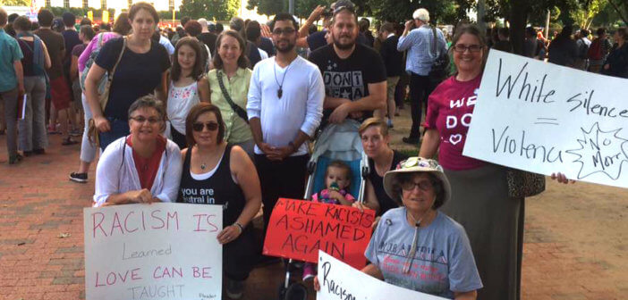 Washington Ethical Society members holding signs protesting white supremacy