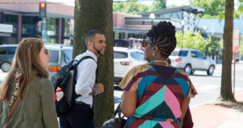 People chatting on a sidewalk in town