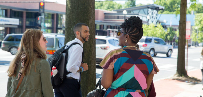 People chatting on a sidewalk in town