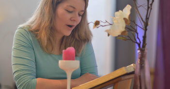 Layperson reading aloud from the Bible in front of the congregation